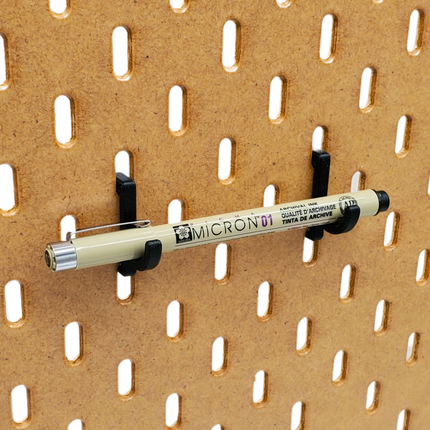 Charcoal Black J-Hook, holding a prop Micron Pen. IKEA SKADIS accessory