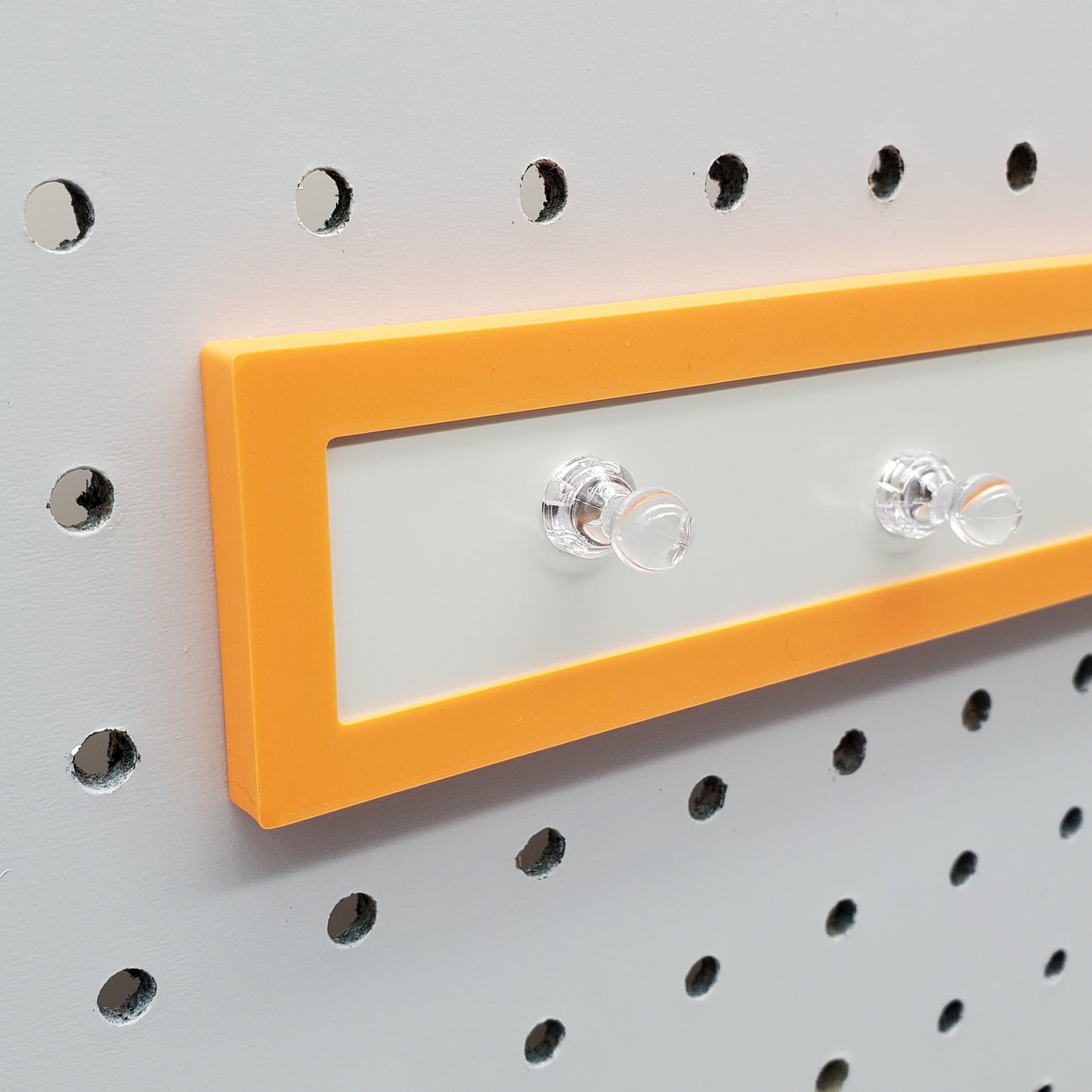 Close up of sunrise orange Magnet board for pegboard organization