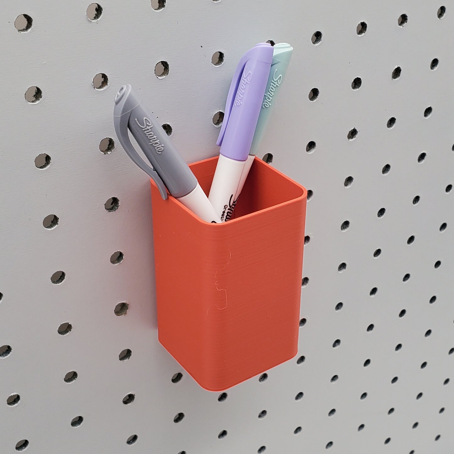 Small square bin in muted red.