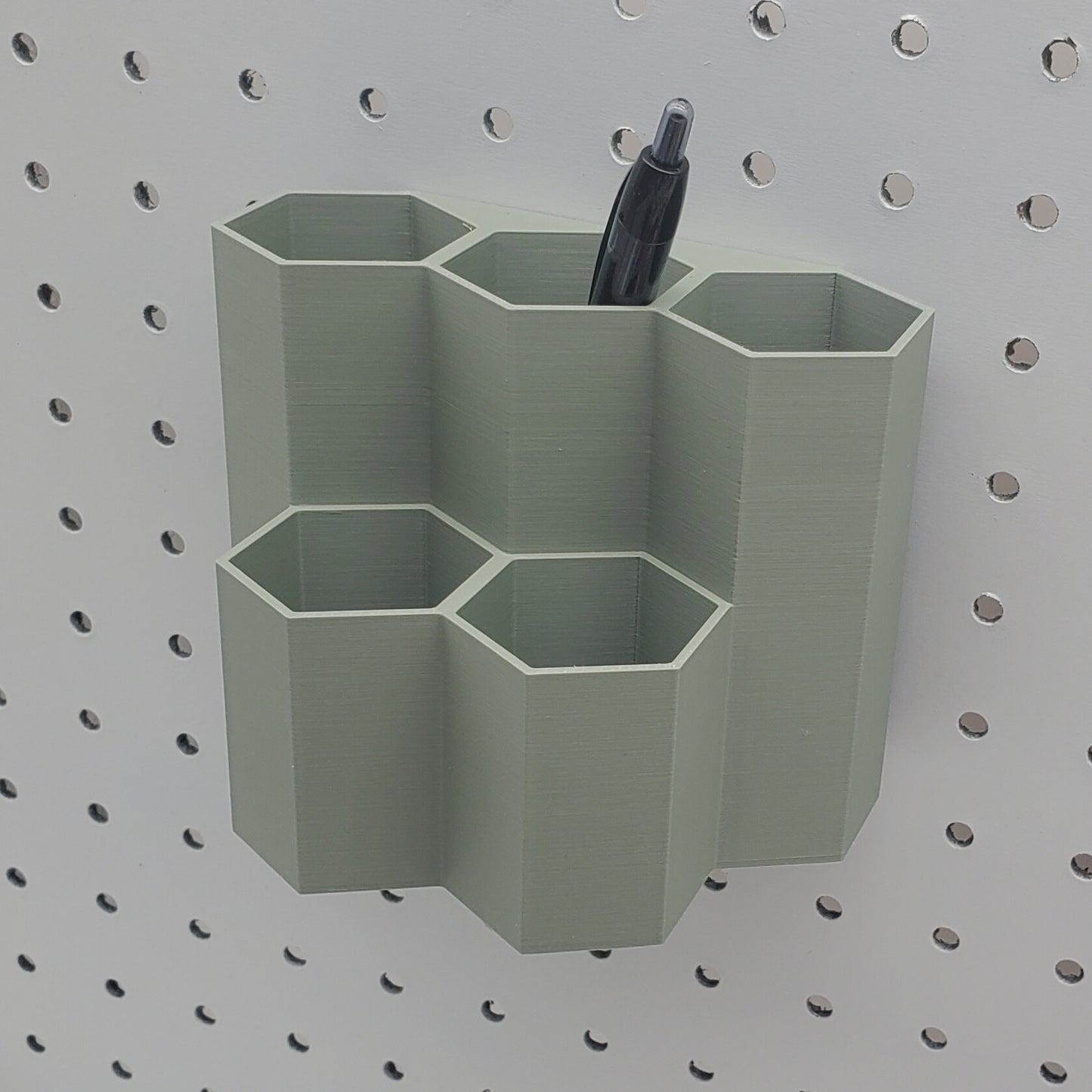 Tall Muted green 1/4" Pegboard 5 cup hex bin.