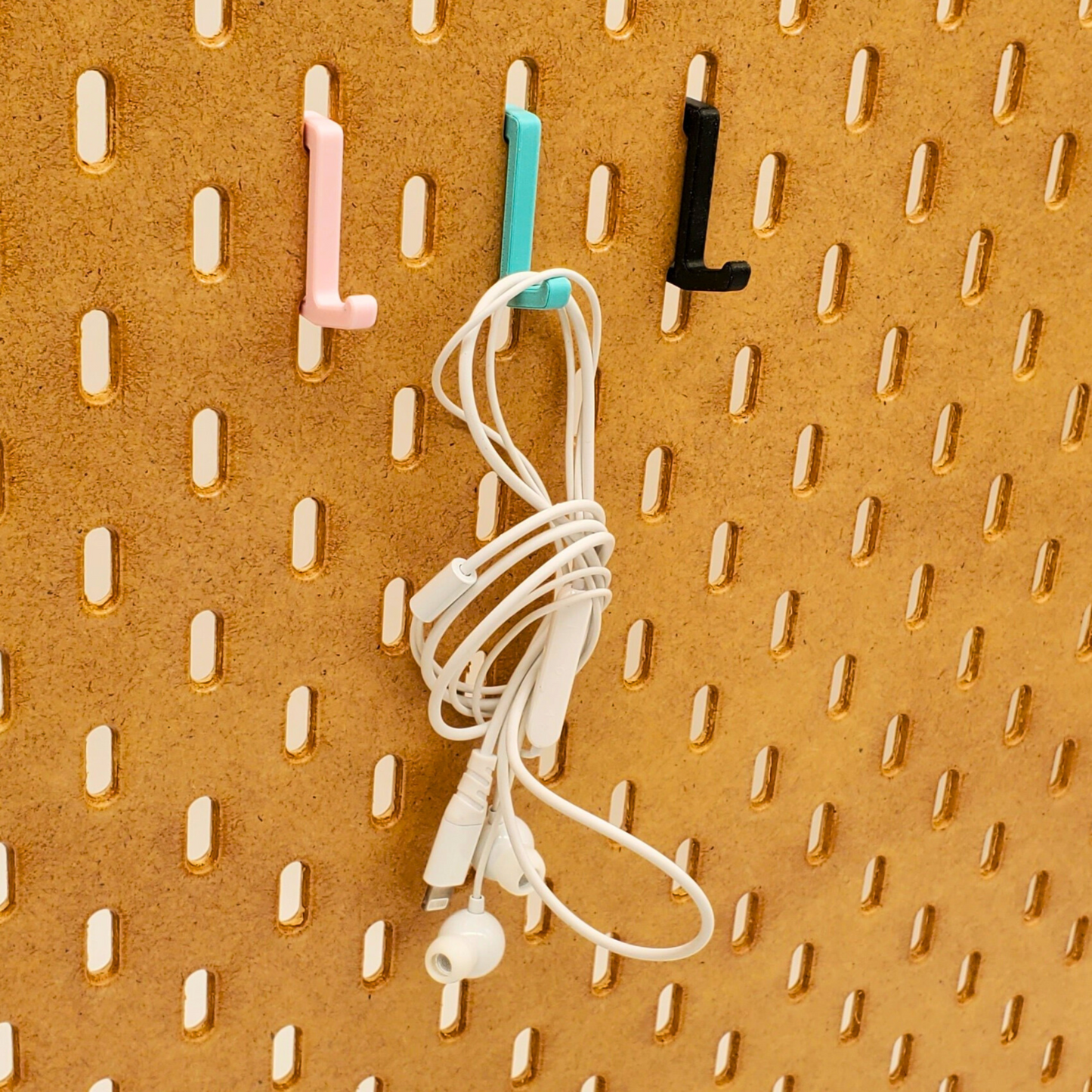 Teal SKADIS Pegboard Hook hanging earbuds