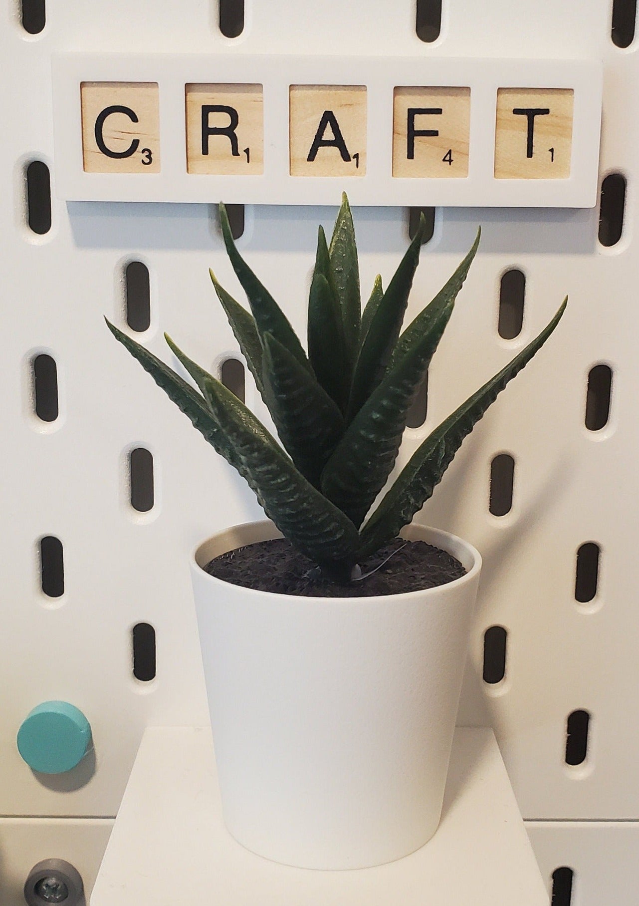 the word 'Craft' in cotton white SKADIS Accessory sign in front of an IKEA plant
