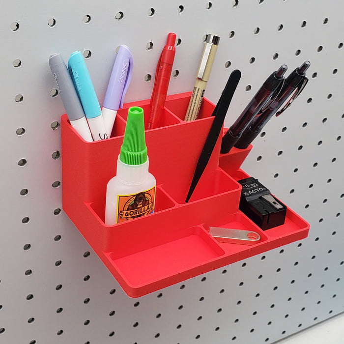 A red bin on a white pegboard