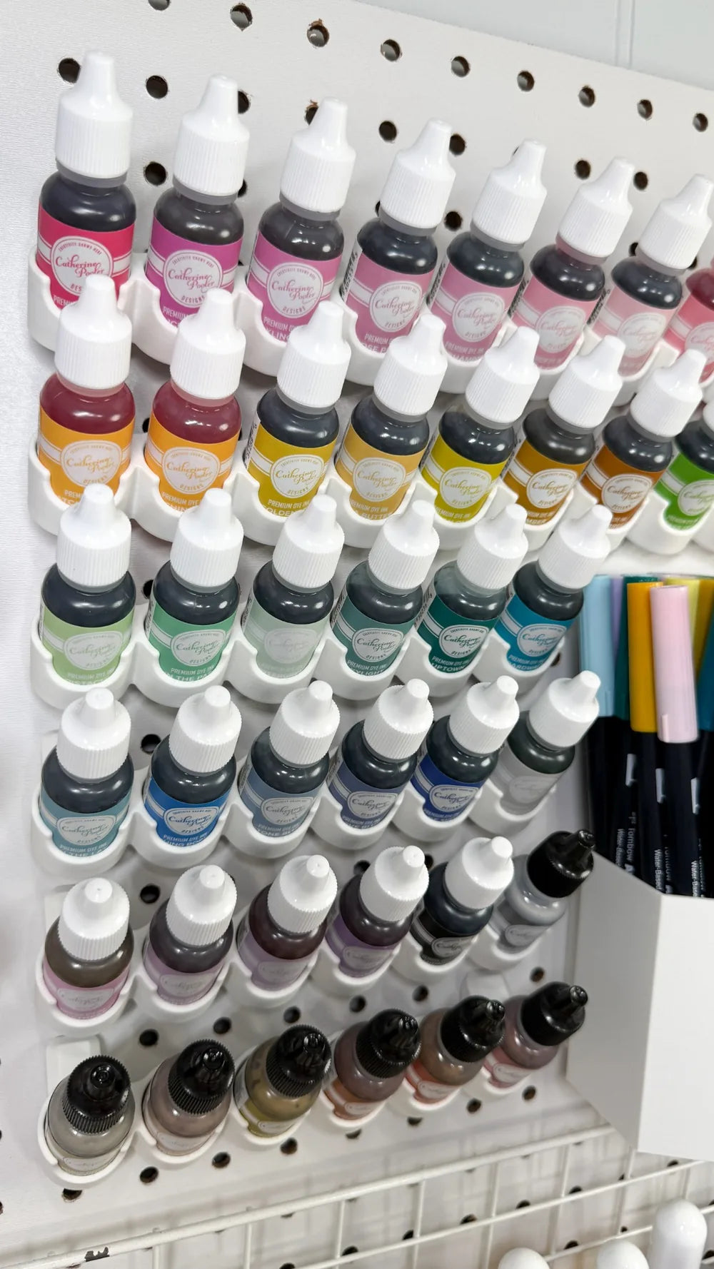 Andrea Lake’s craft room pegboard with organized creative supplies and modular storage.