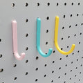 Small, Medium, and Large J Hooks in Light Pink, Teal, and Savannah Yellow on 1/4" pegboard.