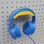 Headphone Holder in Savannah Yellow with blue headphones on 1/4" pegboard.