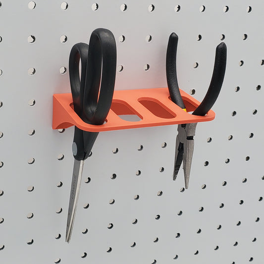 Scissor Holder in muted red on a 1/4" pegboard
