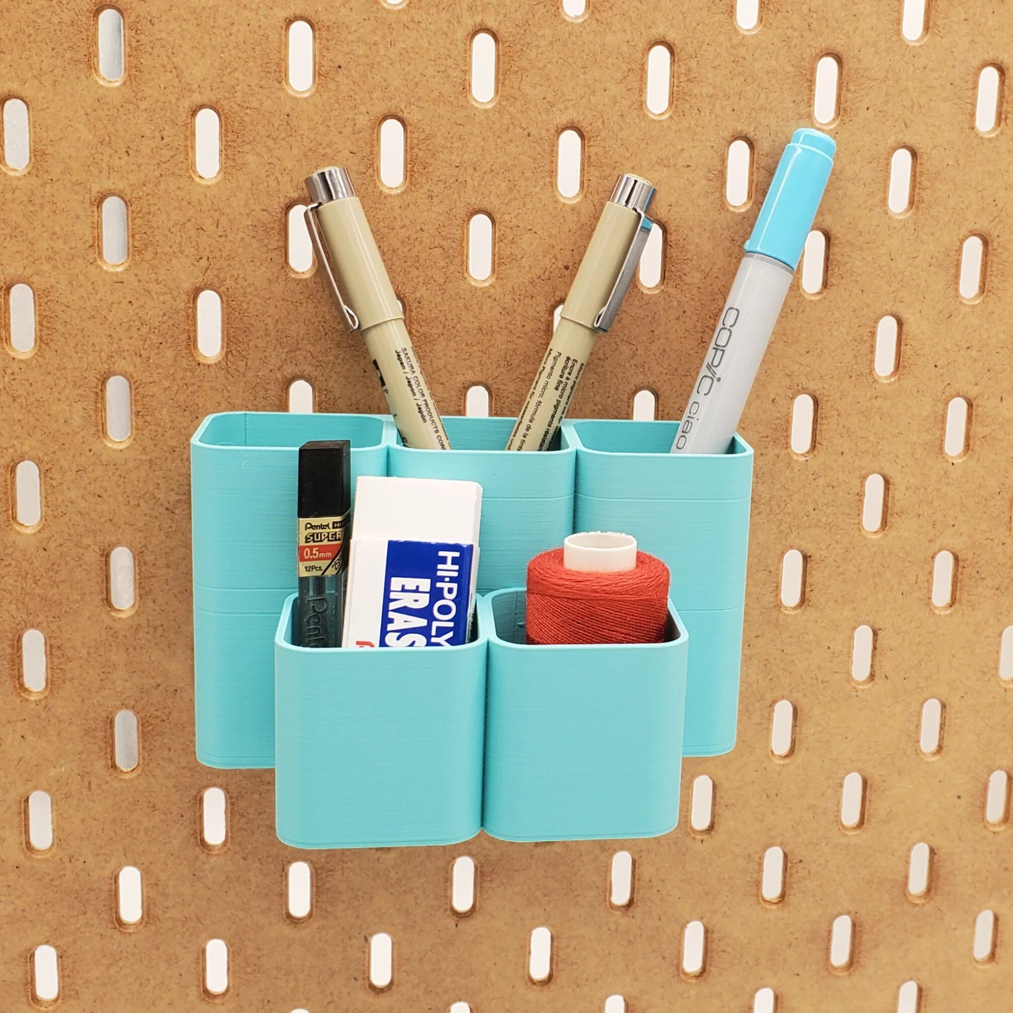 Tall Square Tiered Pen and Pencil Organizer in Teal on IKEA SKADIS pegboard with pens.