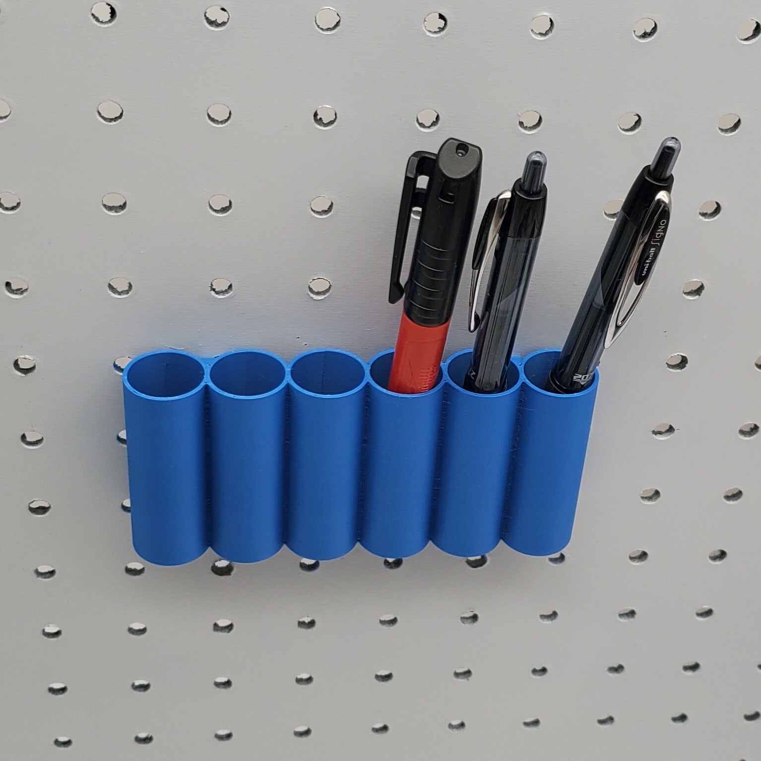 Blue 6 circle bin with three writing utensils
