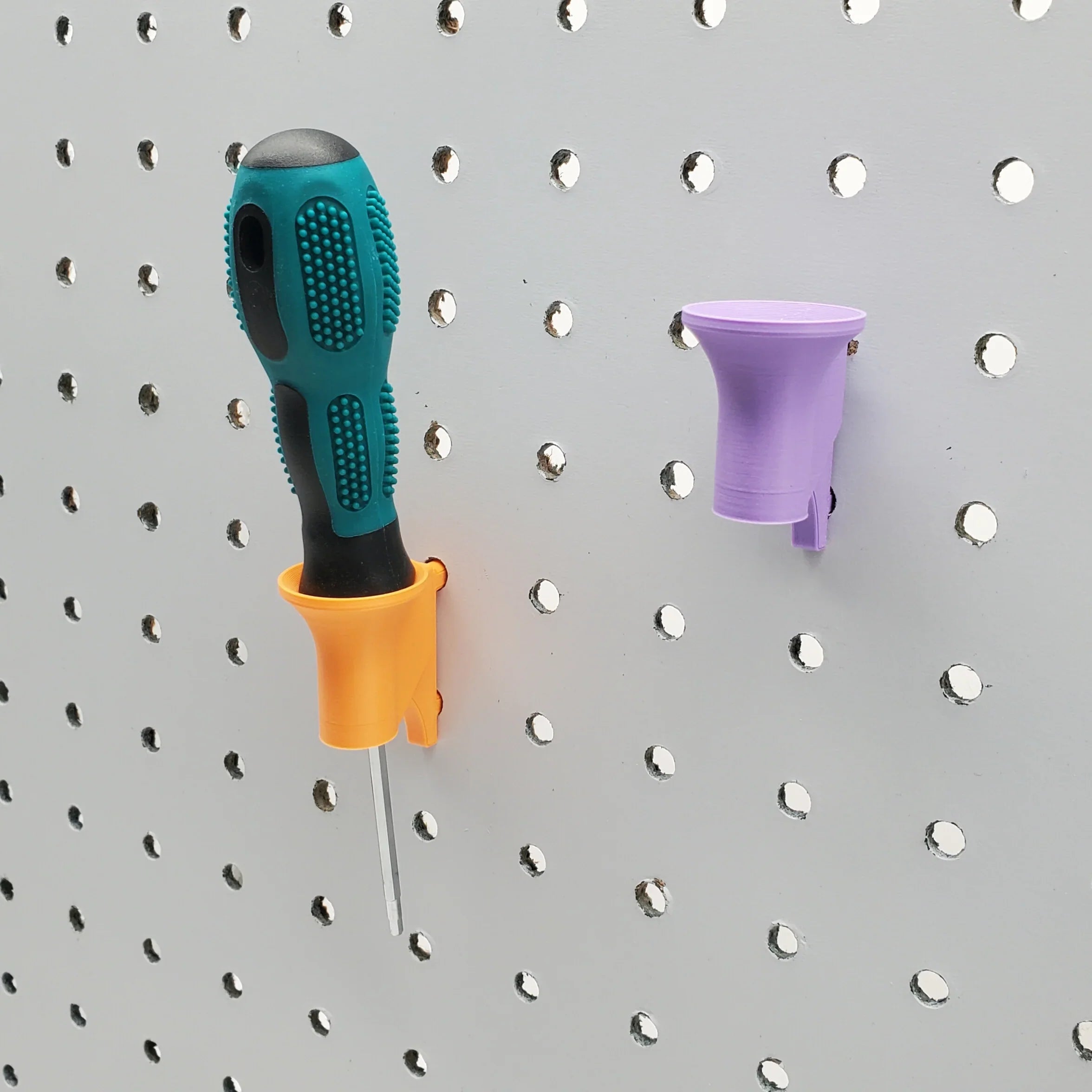 Two Single Screwdriver Holders in Sunrise Orange and Lavender Purple on 1/4" pegboard.
