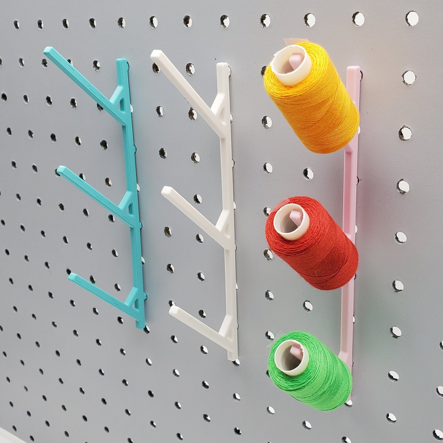 Three Large Thread Racks in Teal, Cotton White, and Light Pink on 1/4" pegboard with thread spools.