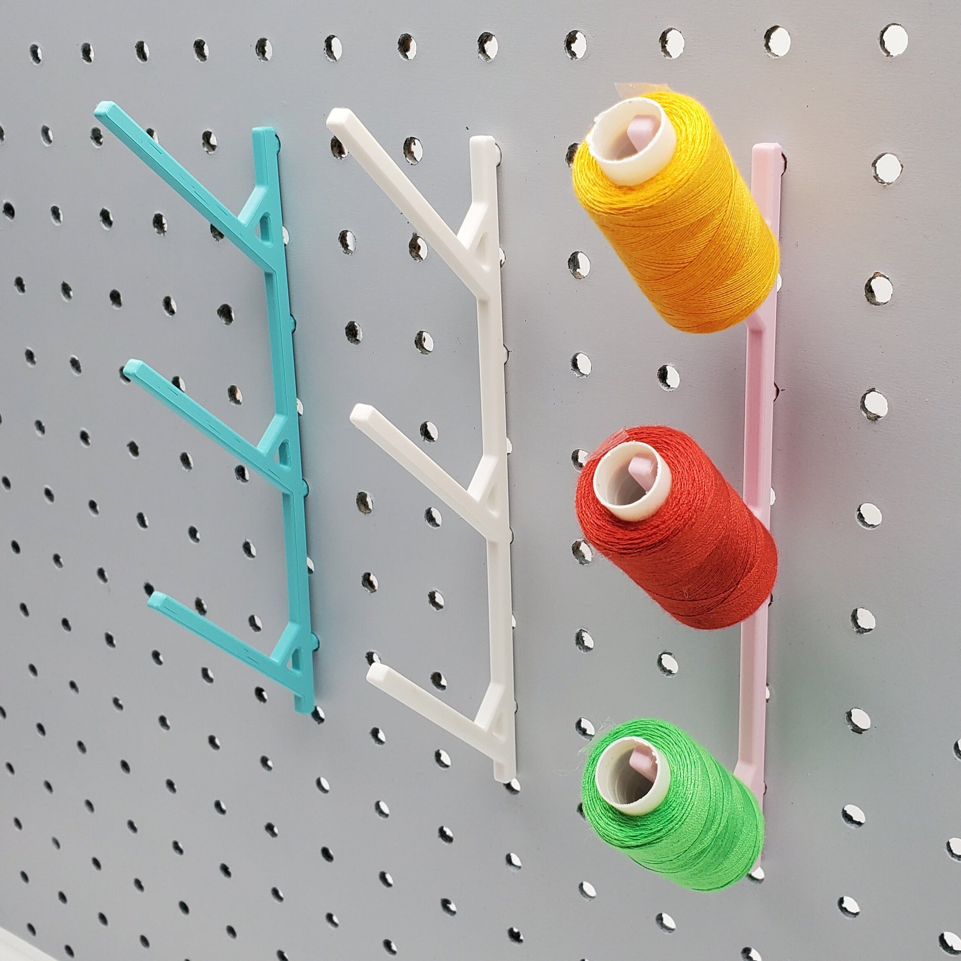 Three Large Thread Racks in Teal, Cotton White, and Light Pink on 1/4" pegboard with thread spools.