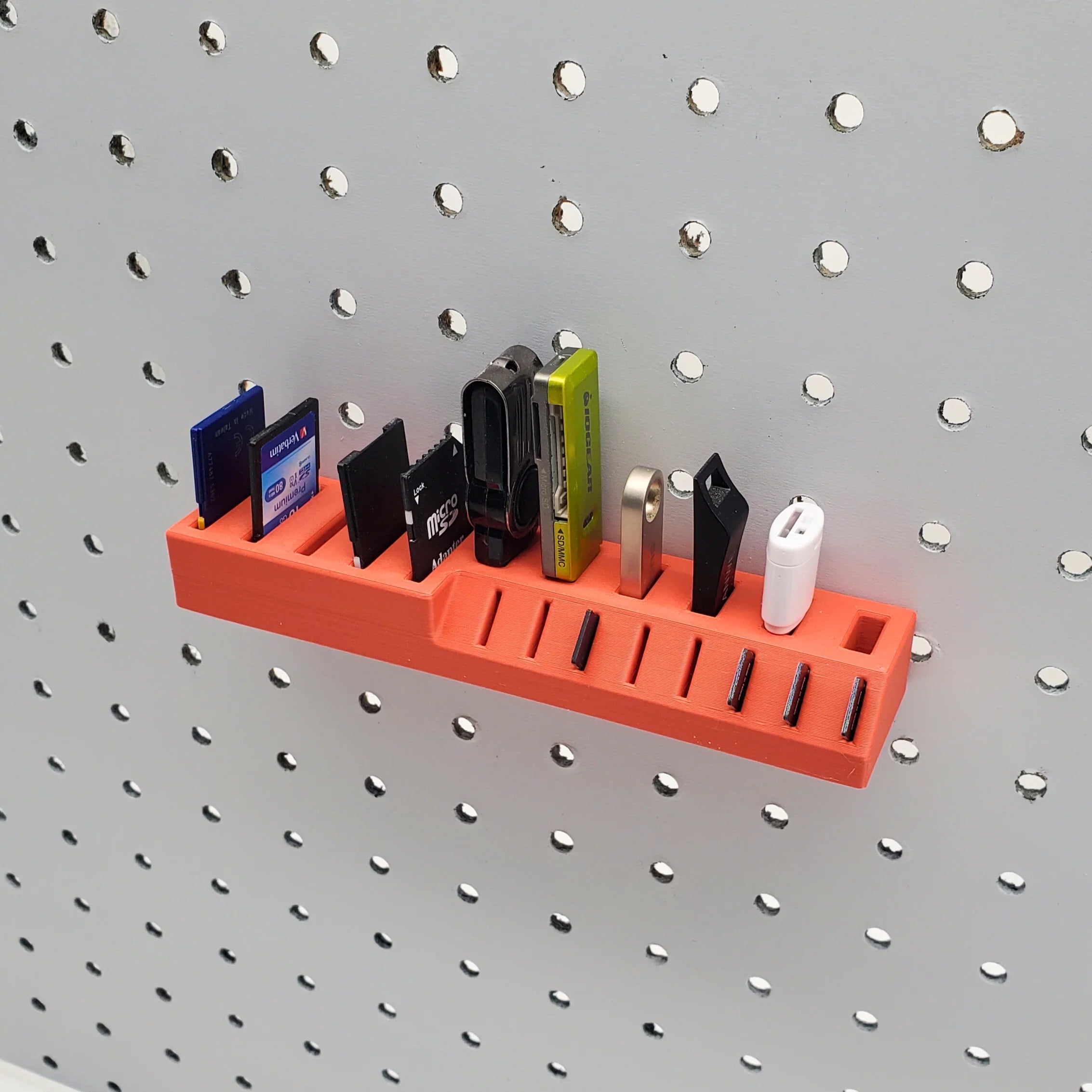 Large Memory Card Holder in Lava Red on 1/4" pegboard.