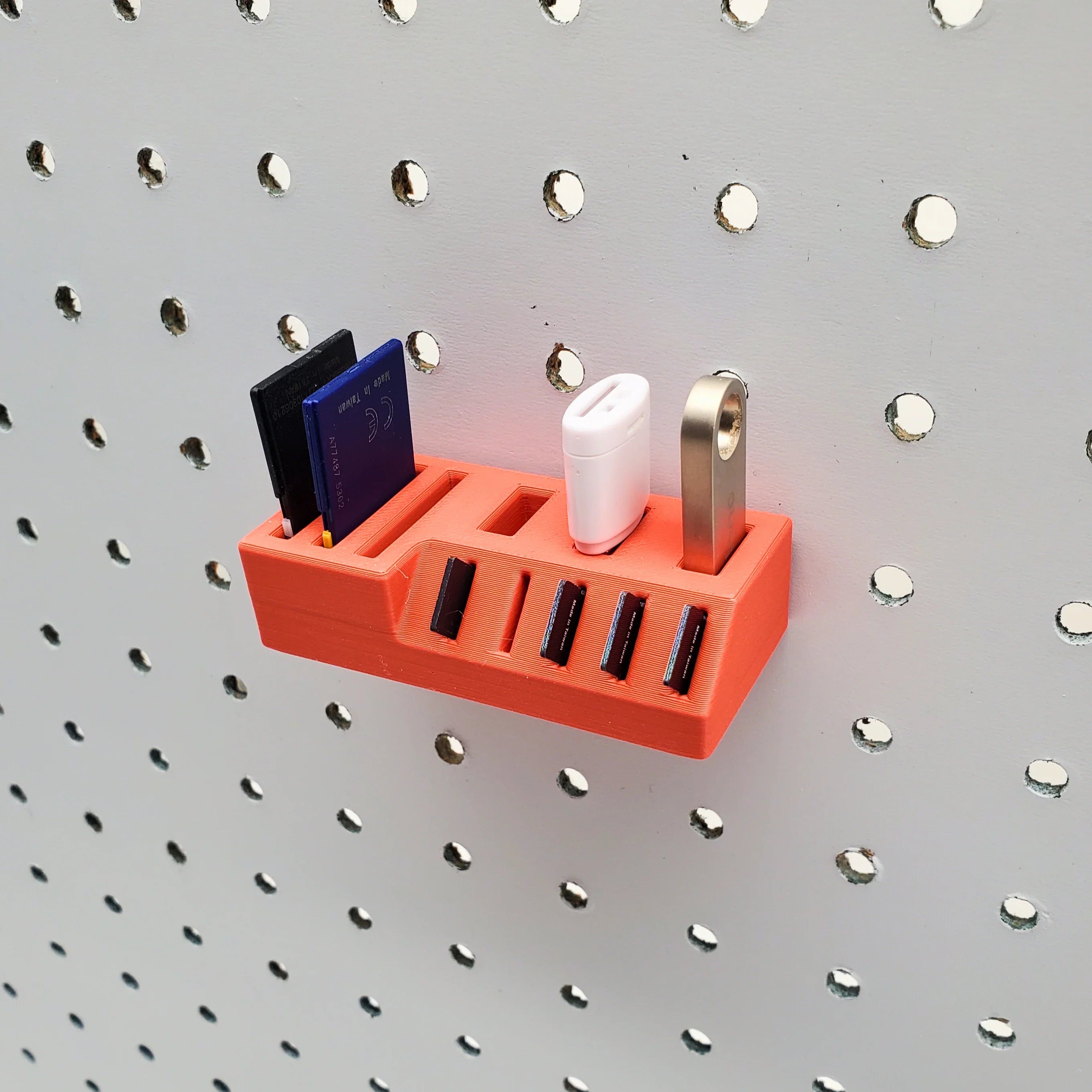 Small Memory Card Holder in Lava Red on 1/4" pegboard.