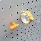 Washi Tape Storage Hooks in Sunrise Orange and Cotton White on 1/4" pegboard with Washi tape.
