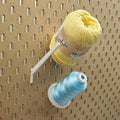 Straight Thread Cone Holders in Light Pink, Lavender Purple, and Teal on 1/4" pegboard with thread cones.