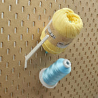Straight Thread Cone Holders in Light Pink, Lavender Purple, and Teal on 1/4" pegboard with thread cones.