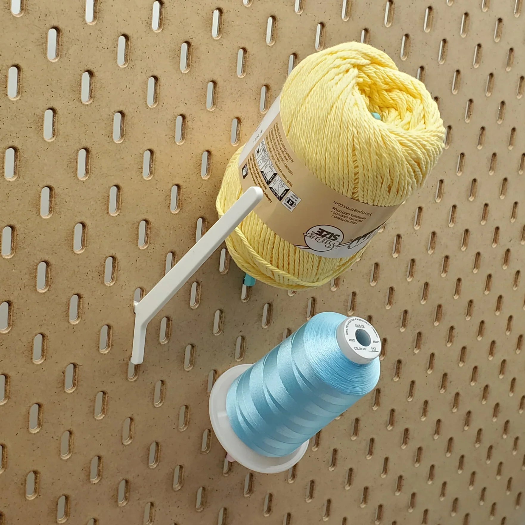 Straight Thread Cone Holders in Light Pink, Lavender Purple, and Teal on 1/4" pegboard with thread cones.