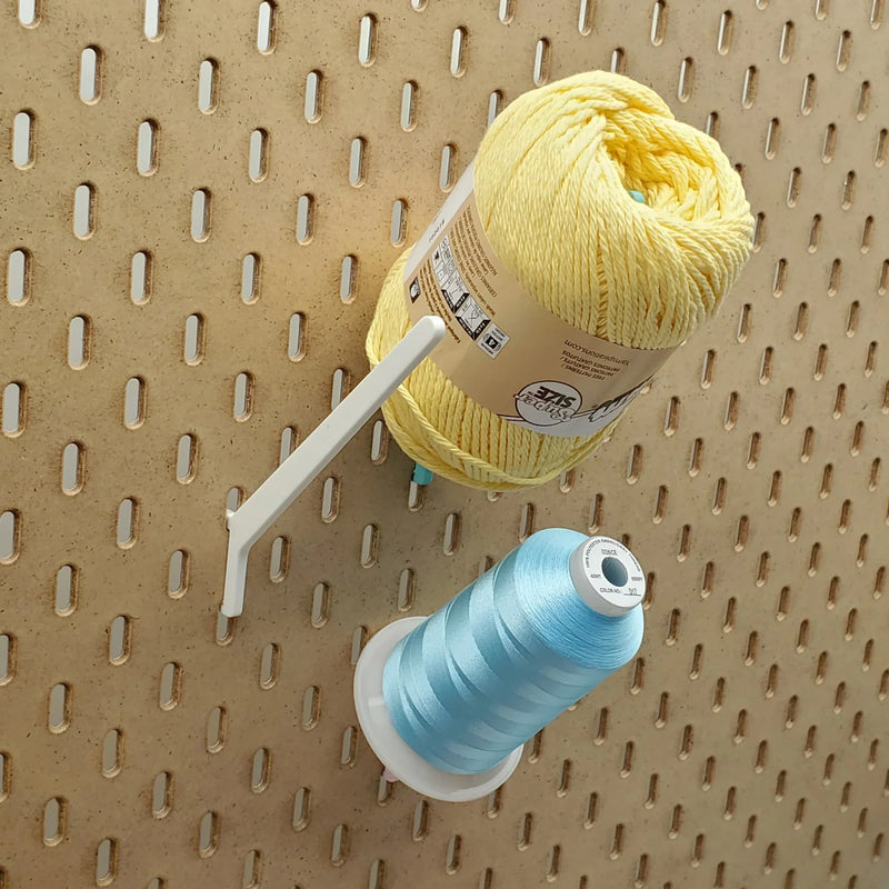Straight Thread Cone Holders in Light Pink, Lavender Purple, and Teal on 1/4" pegboard with thread cones.
