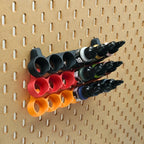 Three 22mL Pro Acryl paint racks in Sunrise Orange, Lava Red, and chacoal black on IKEA SKADIS pegboard.