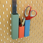 Three Square Pen Tubes in Muted Green, Lava Red, and Muted Blue on IKEA SKADIS pegboard with scissors, ruler, and pens.