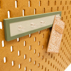 Magnet Board in Muted Green on an IKEA SKADIS pegboard with magnets and notes.