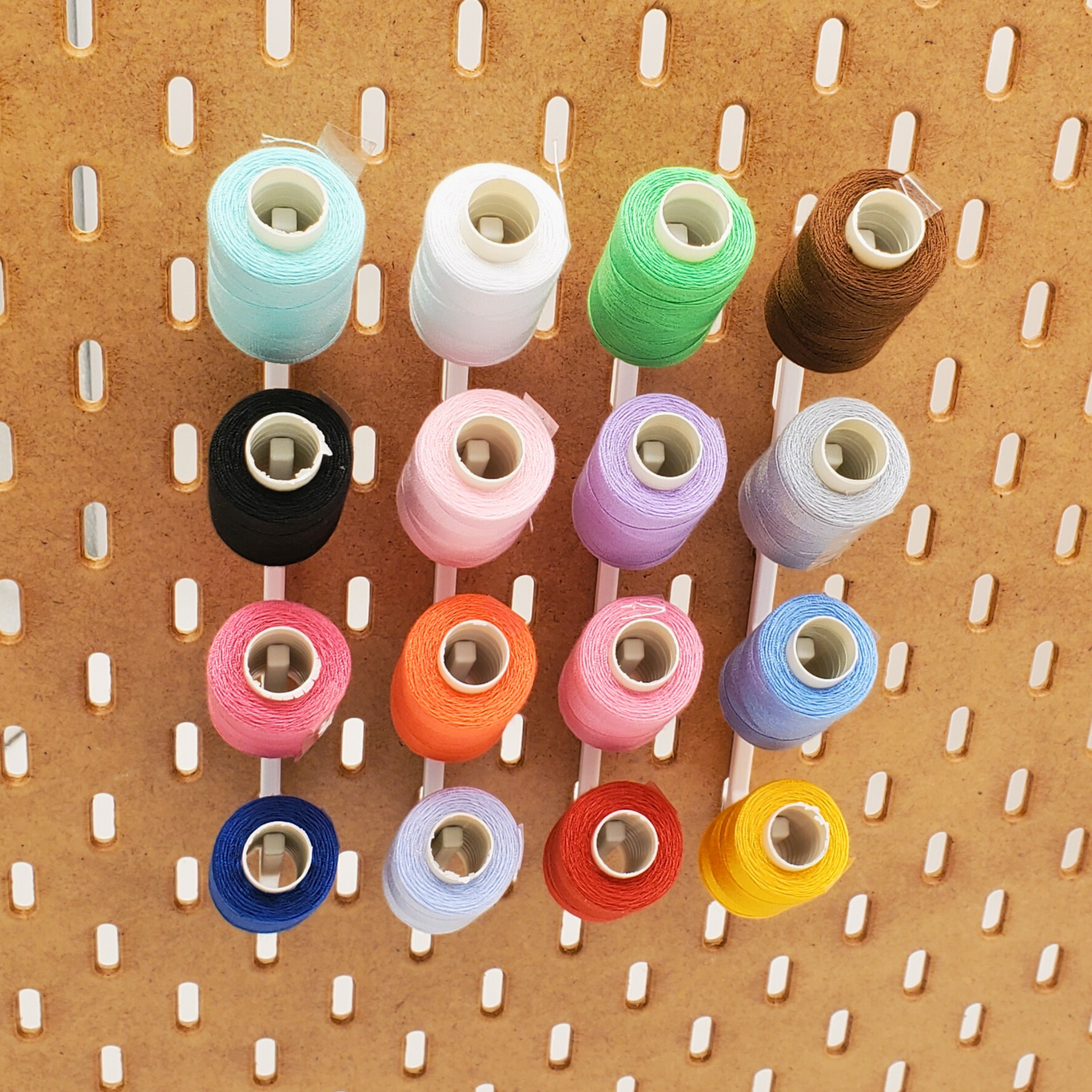 Four 4 Spot thread holders with thread displayed on Wooden IKEA SKADIS pegboard
