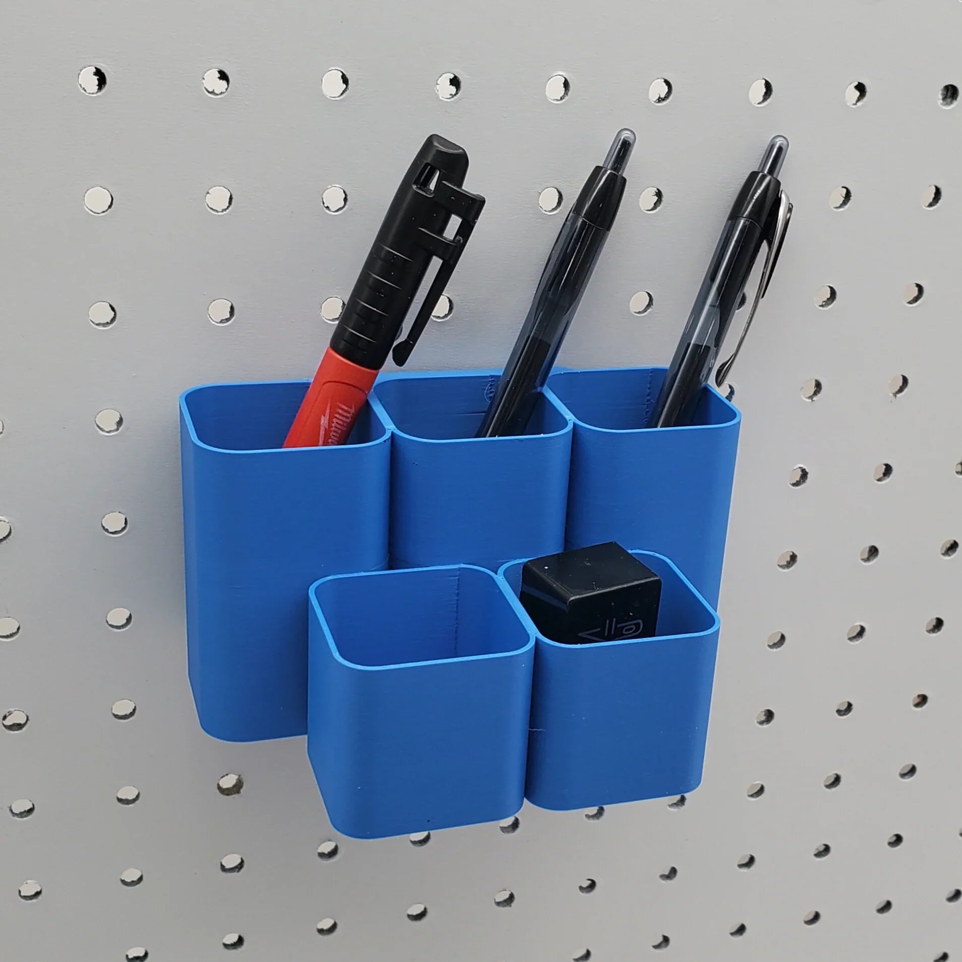 Square Tiered Pen and Pencil Organizer in Sapphire Blue on 1/4" pegboard with pens.
