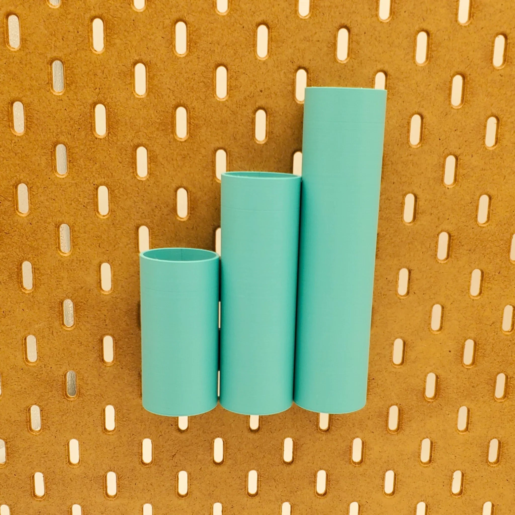 3 Pack of Small, Medium, and Large Cylinder Pen Tubes in Teal on IKEA SKADIS pegboard.