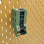 Muted Green Dual Battery Dispenser with batteries on IKEA SKADIS pegboard.