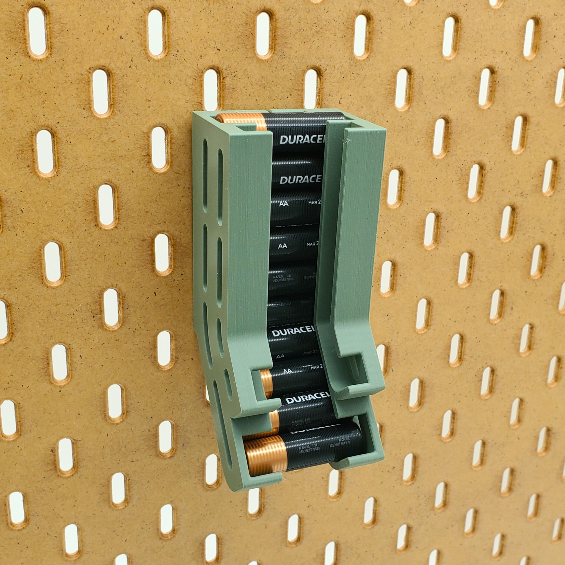 Muted green battery dispenser with just AA batteries installed