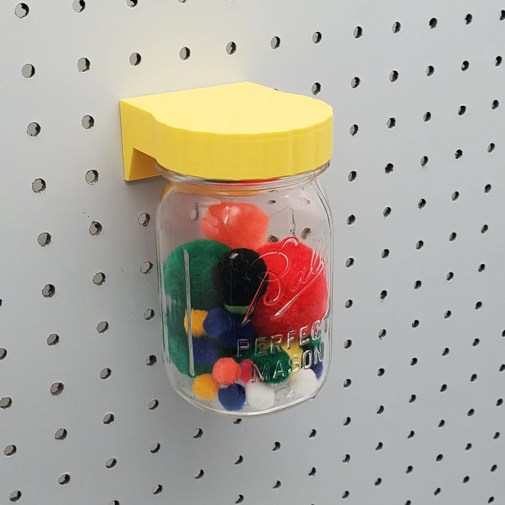 Mason Jar Storage lid in Savannah Yellow on 1/4" pegboard.