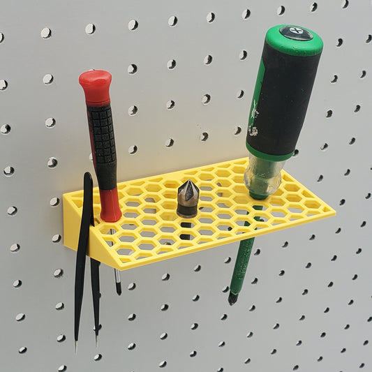 Yellow screwdriver holder on pegboard