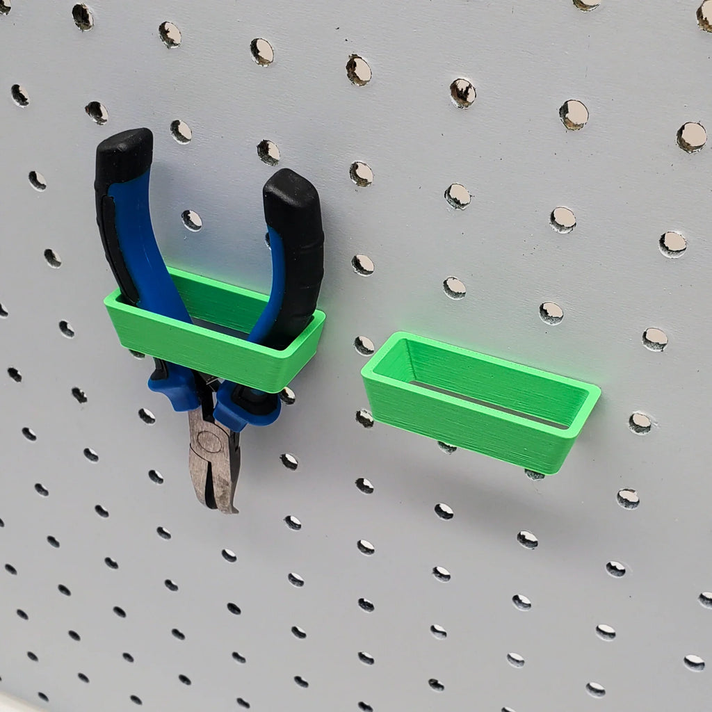 Two Scissor Holders in Forest Green on 1/4" pegboard with pliers.
