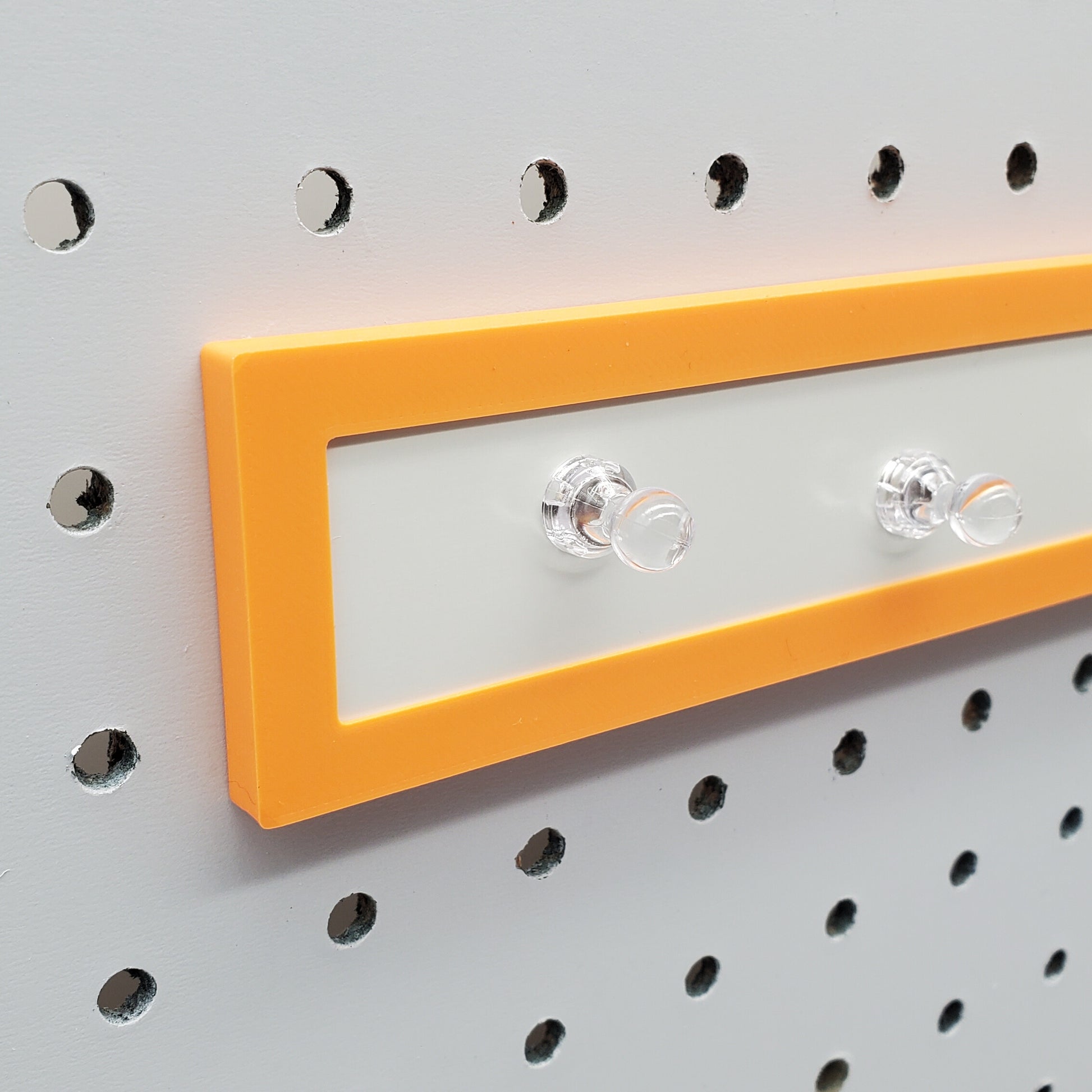 Close up of sunrise orange Magnet board for pegboard organization