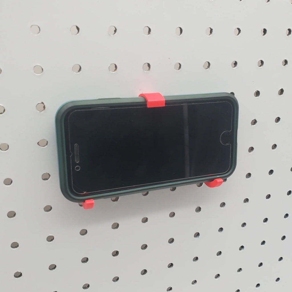 iPhone and Tablet Holder in Lava Red on 1/4" pegboard with iPhone.