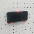 iPhone and Tablet Holder in Lava Red on 1/4" pegboard with iPhone.