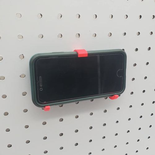iPhone and Tablet Holder in Lava Red on 1/4" pegboard with iPhone.