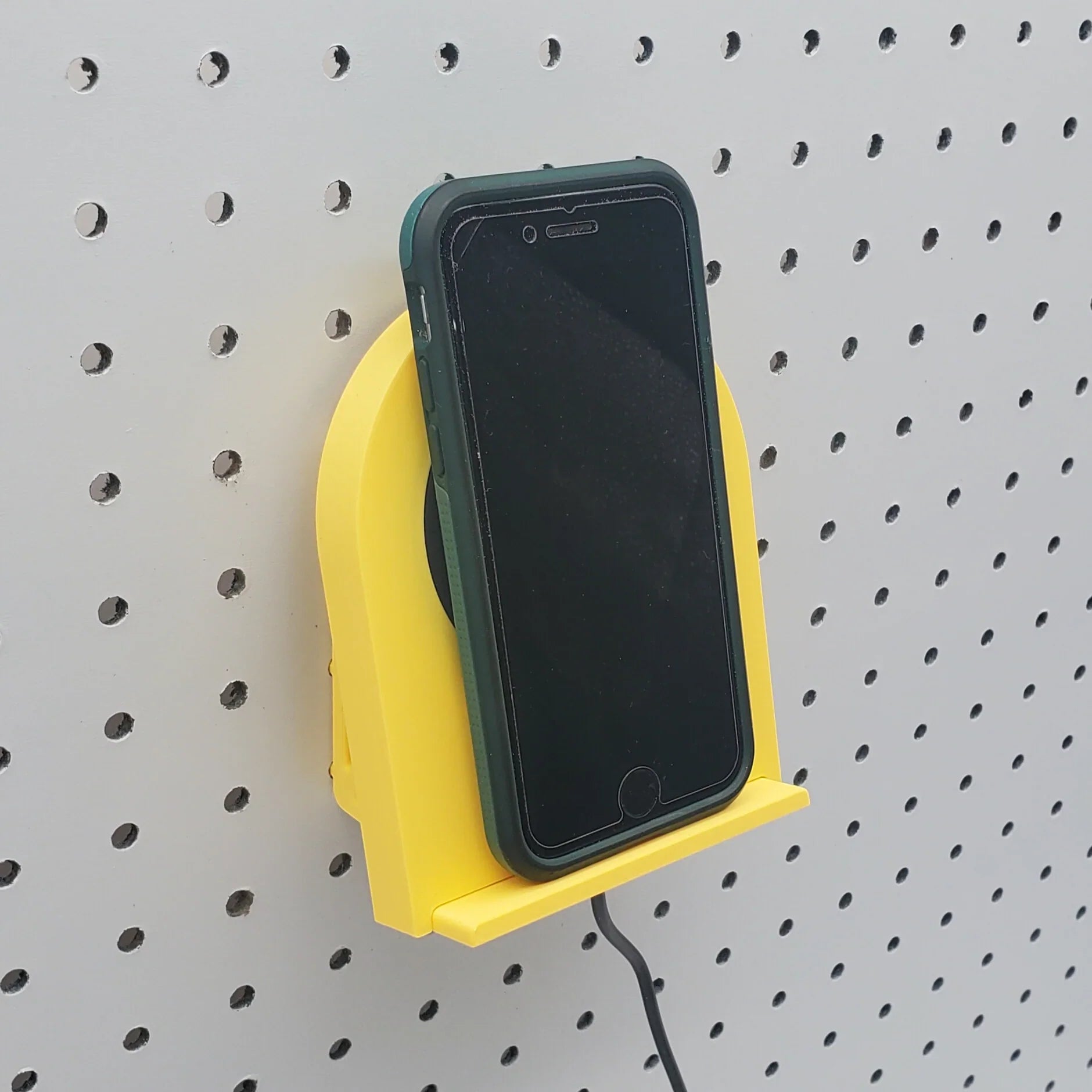 Wireless Phone Charger in Savannah Yellow on 1/4" pegboard with iPhone.