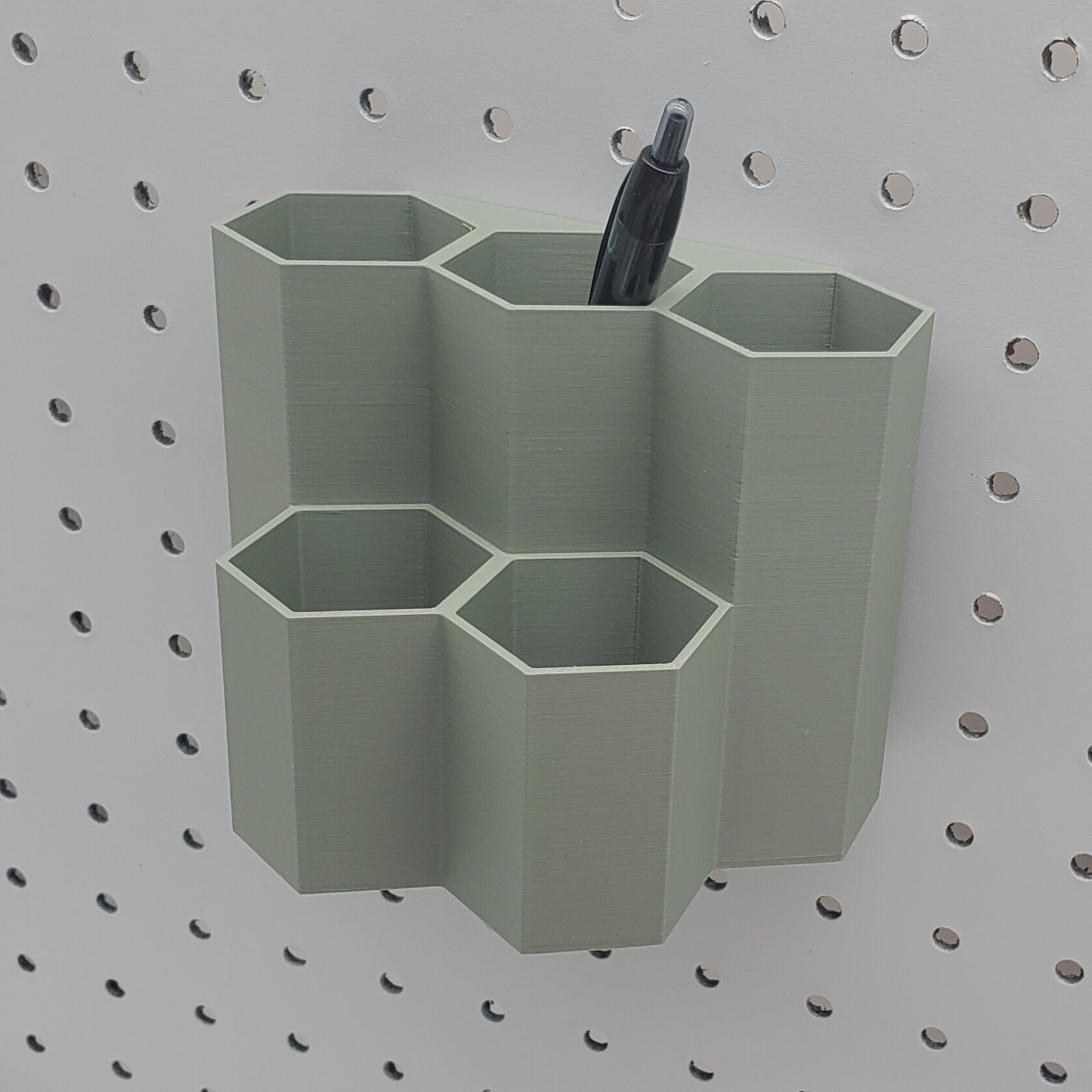 Tall Muted green 1/4" Pegboard 5 cup hex bin.