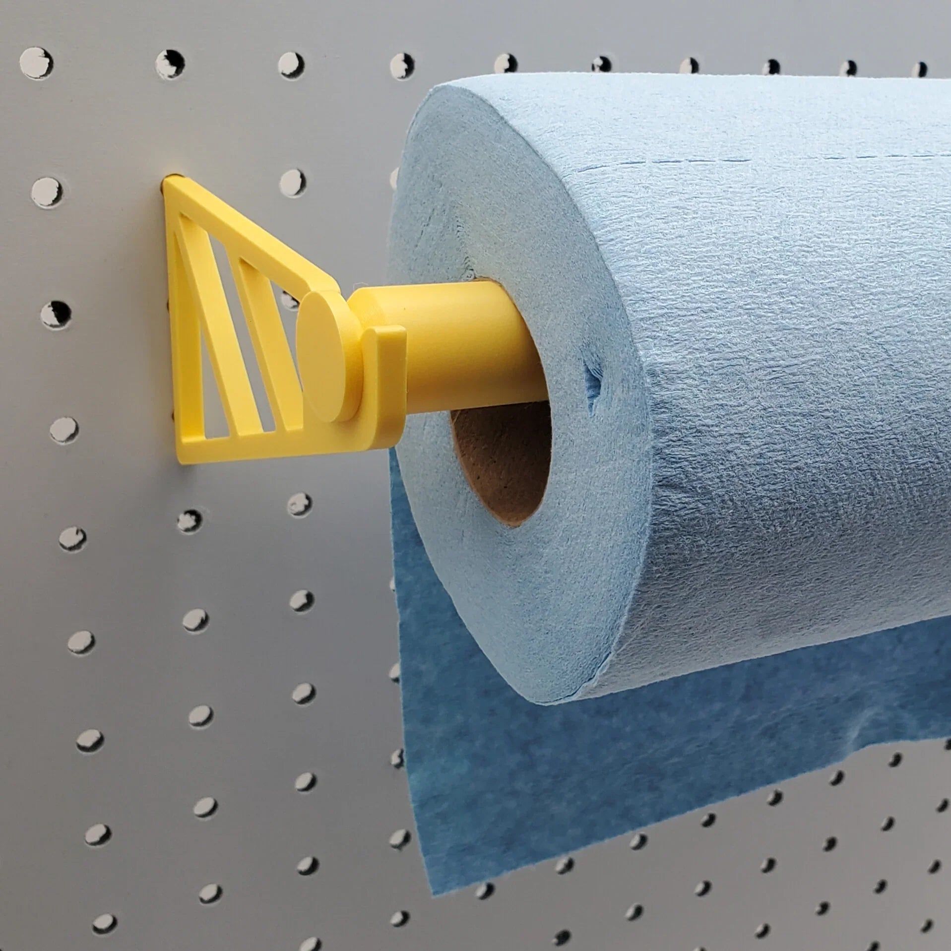Paper Towel Holder in Savannah Yellow on 1/4" pegboard with blue shop towels.