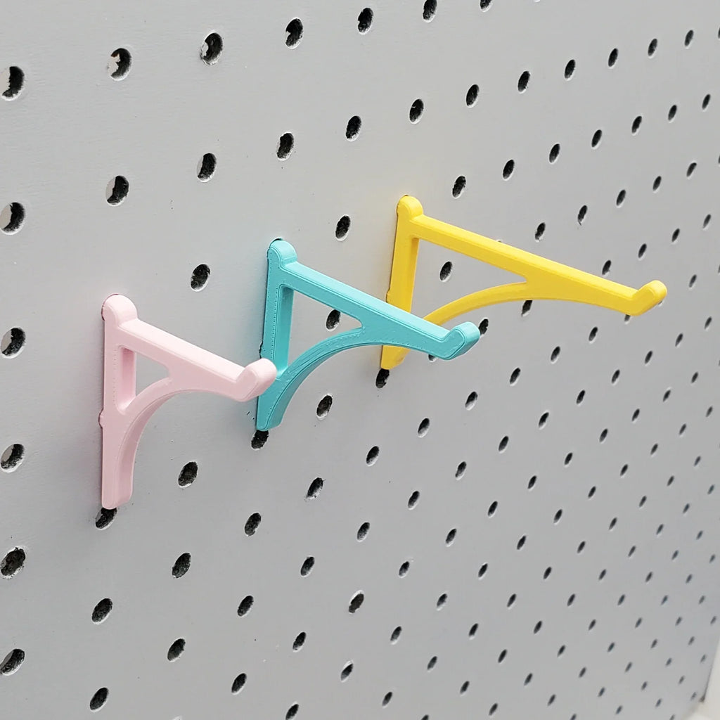 Small, Medium, and Large Platform Hooks in Light Pink, Teal, and Savannah Yellow on 1/4" pegboard.