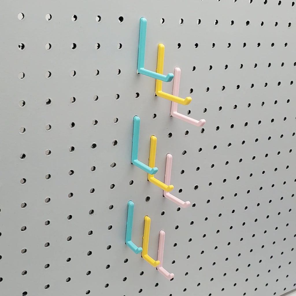 Small, Medium, and Large L Hooks in Light Pink, Teal and Savannah Yellow on 1/4" Pegboard.
