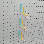 Small, Medium, and Large L Hooks in Light Pink, Teal and Savannah Yellow on 1/4" Pegboard.