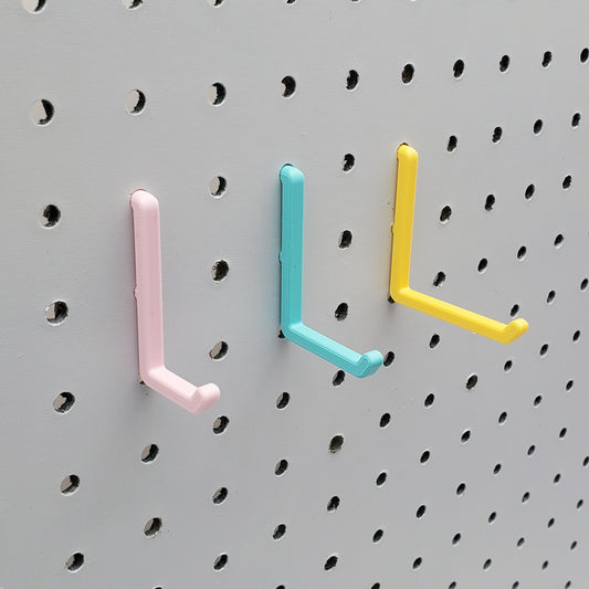 Light Pink, Teal and Savannah Yellow L-Hooks on a 1/4" Pegboard.