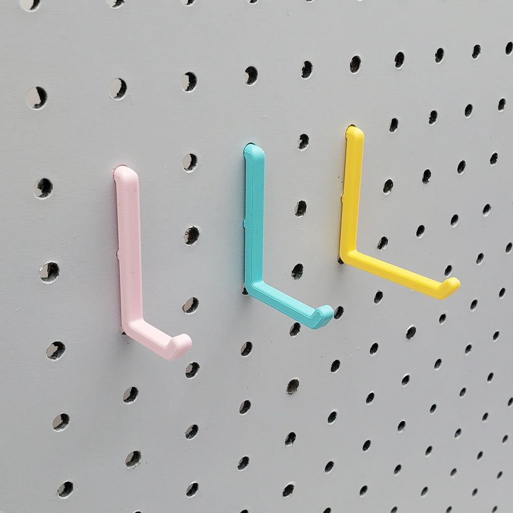 L Hooks in Light Pink, Teal and Savannah Yellow, small, medium, and large on 1/4" pegboard.