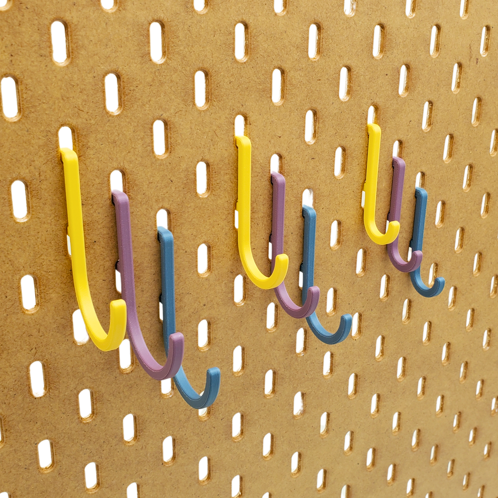 Small, Mediuam and Large J-hooks in Muted Blue, Muted Purple and Savannah Yellow J-hooks for  SKADIS Pegboards
