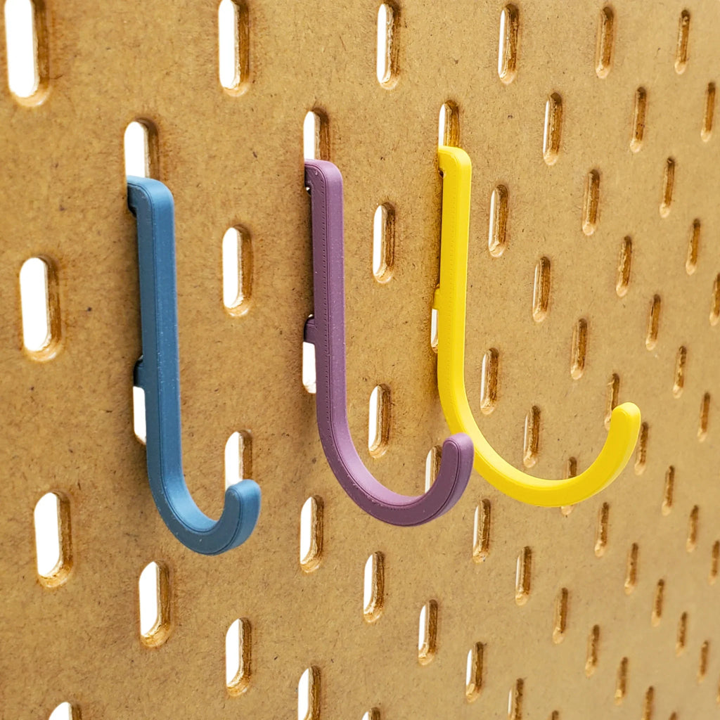 Small, Medium, and Large J Hooks in Muted Blue, Muted Purple, and Savannah Yellow on IKEA SKADIS pegboard.