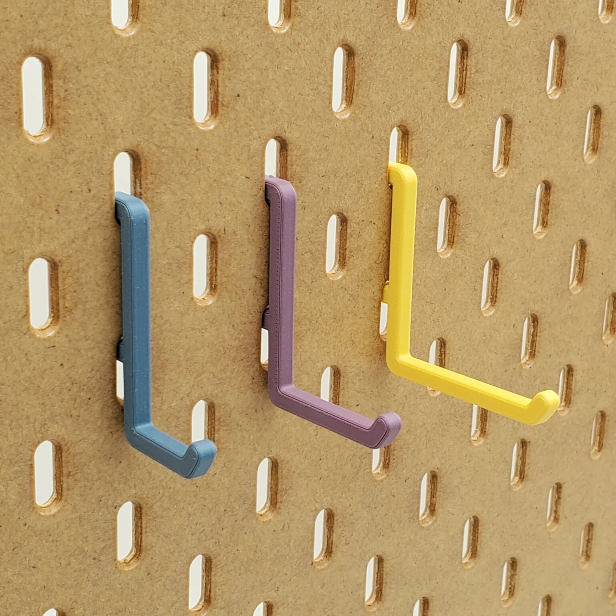 Small, Medium, and Large L Hooks in Muted Blue, Muted Purple, Savannah Yellow on IKEA SKADIS pegboard.