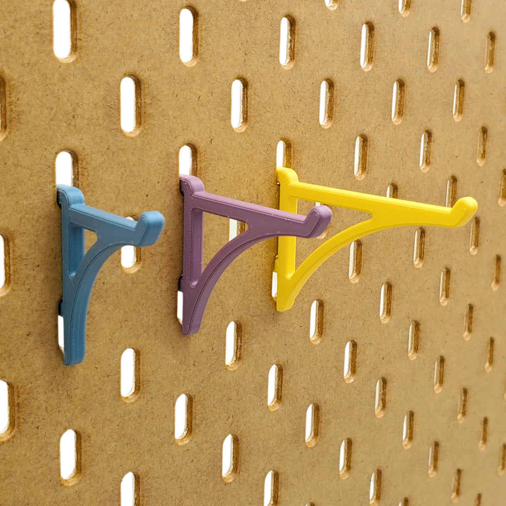 Small, Medium, Large Platform Hooks in Muted Blue, Muted Purple, and Savannah Yellow on IKEA SKADIS Pegboard.